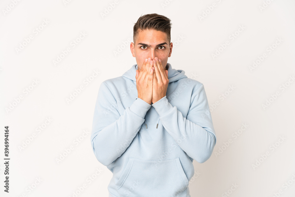 Young caucasian handsome man isolated shocked, covering mouth with hands, anxious to discover something new. Young caucasian handsome man isolated shocked, covering mouth with hands, anxious to discover something new.