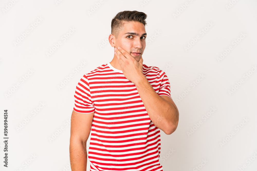 Young caucasian handsome man isolated touching back of head, thinking and making a choice. Young caucasian handsome man isolated touching back of head, thinking and making a choice.