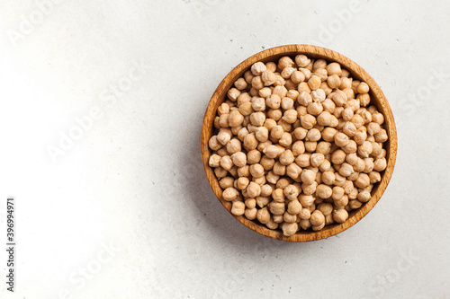 Raw chickpeas in a wooden bowl. Superfood. Copy space.