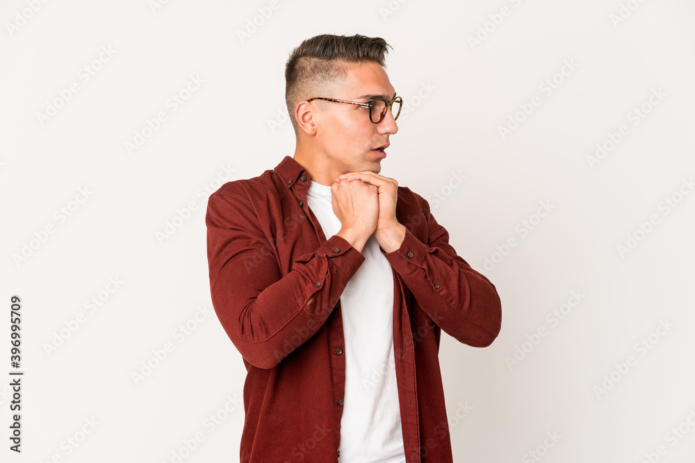 Young caucasian handsome man isolated praying for luck, amazed and opening mouth looking to front. Young caucasian handsome man isolated praying for luck, amazed and opening mouth looking to front.