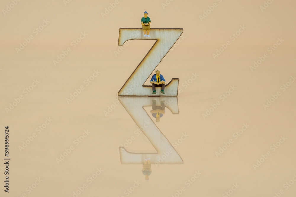 miniature people sitting on a letter