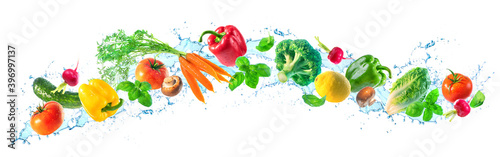 Fresh vegetables and water splashes on panoramic background
