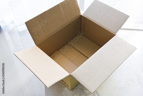Open cardboard box on floor background, High angle view of an empty cardboard box or Parcel box. © Bigc Studio