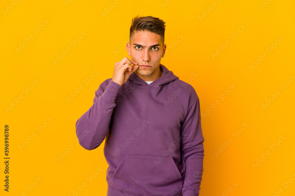Young handsome caucasian man isolated with fingers on lips keeping a secret. Young handsome caucasian man isolated with fingers on lips keeping a secret.