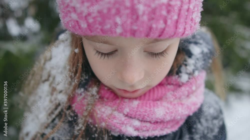 Girl with snowy hair looks down. Close-up. Girl with snowy hair looks down. Close-up.