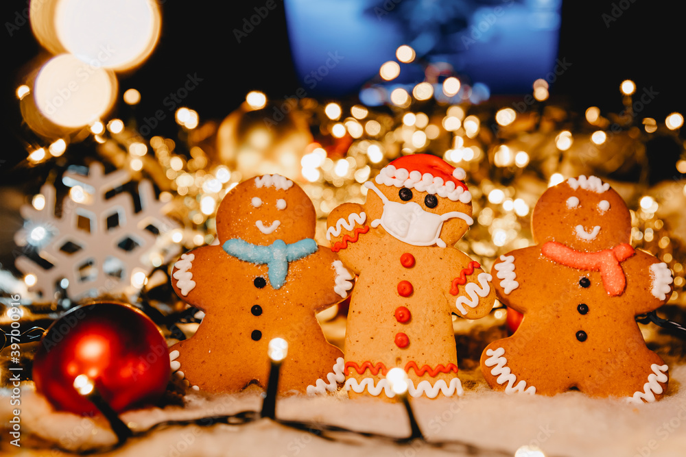 Obraz premium Special New Year's background with elements of the Christmas cookies, festive lights, Christmas ornaments. Covid xmas concept
