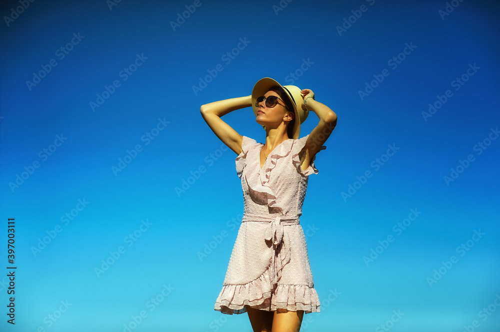 Portrait of a young woman in sunglasses against a blue sky Portrait of a young woman in sunglasses against a blue sky