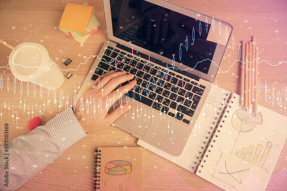 Double exposure of man's hands typing over computer keyboard and forex graph hologram drawing. Top view. Financial markets concept. Double exposure of man's hands typing over computer keyboard and forex graph hologram drawing. Top view. Financial markets concept.