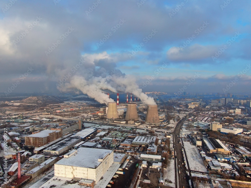 Obraz premium Aerial view smoke from pipes of a large industrial enterprise. Pollution of the ecology of the big city. Thermal energy generation.
