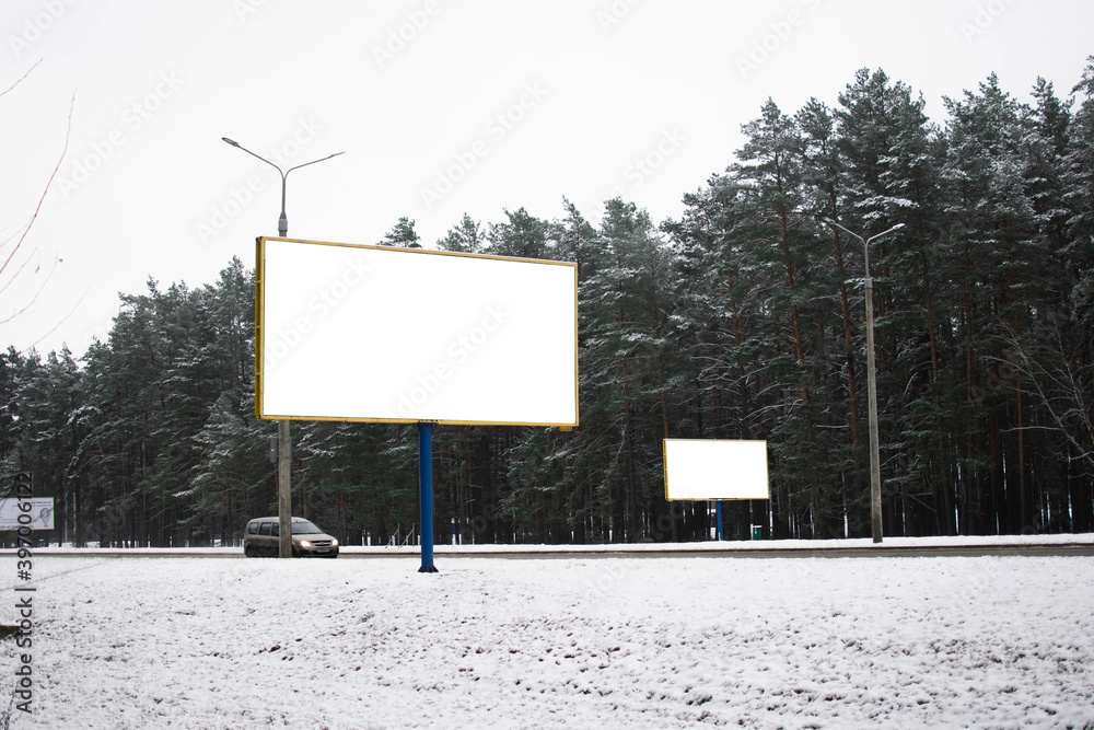 a white Billboard is located by the road