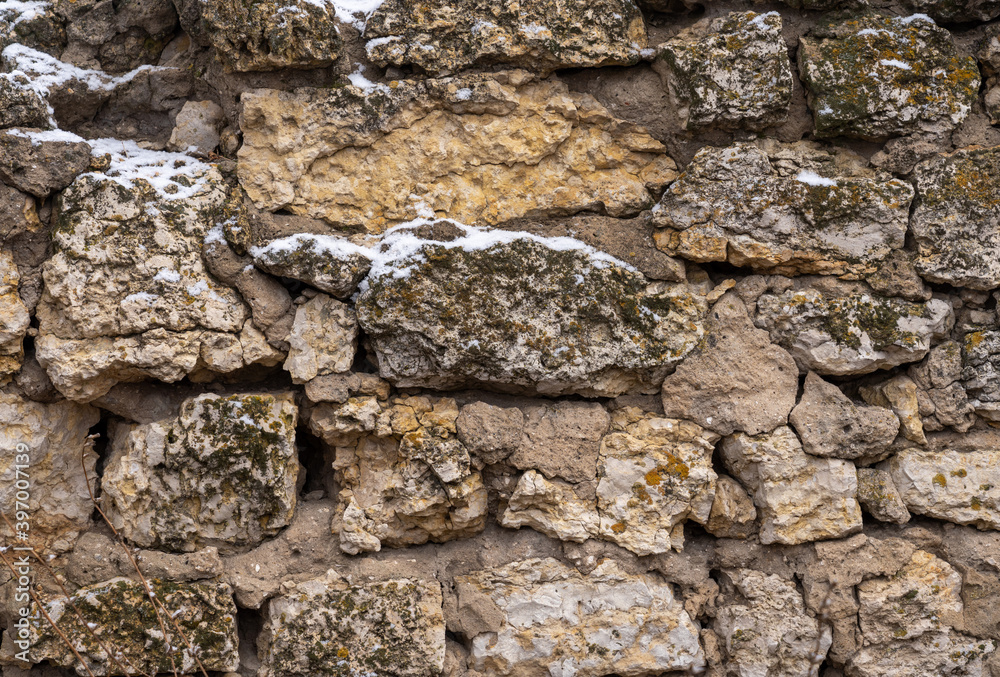 ancient masonry close up cracked with time and overgrown with moss ancient masonry close up cracked with time and overgrown with moss