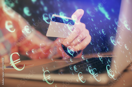 Double exposure of man hands holding a credit card and Forex graph drawing. Stock trading and digital fintech in Internet E-commerce concept.