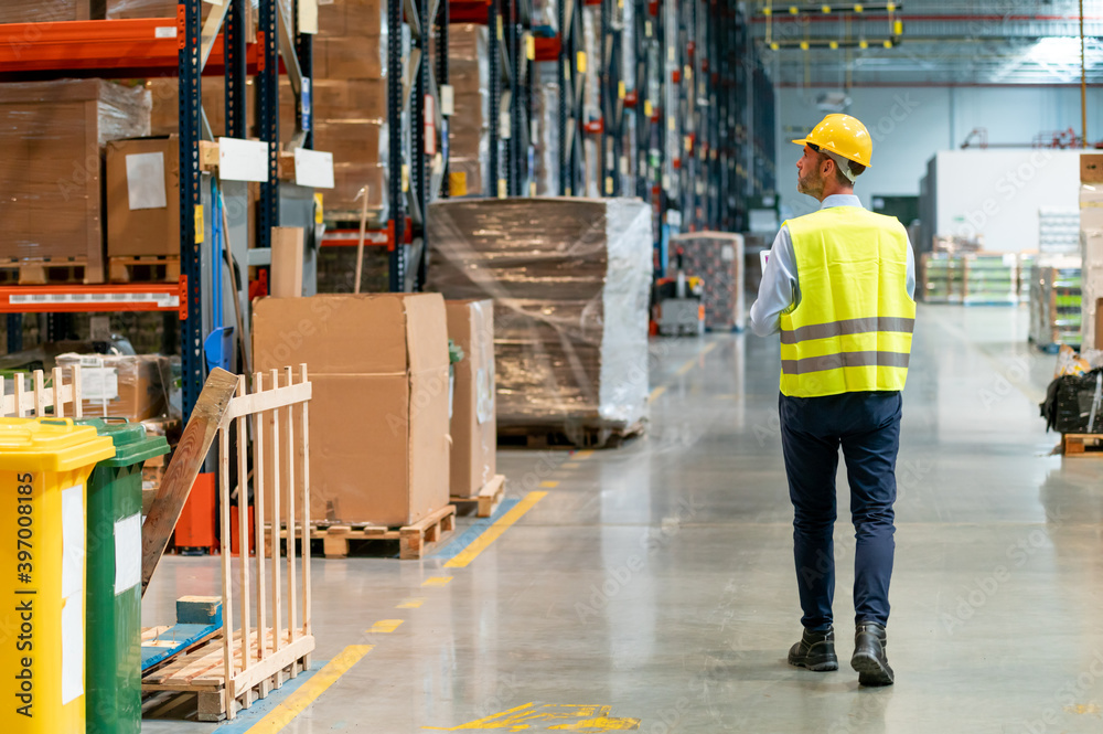 Warehouse worker using laptop and entering data to database Warehouse worker using laptop and entering data to database