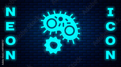 Glowing neon Virus icon isolated on brick wall background. Corona virus 2019-nCoV. Bacteria and germs, cell cancer, microbe, fungi. Vector.