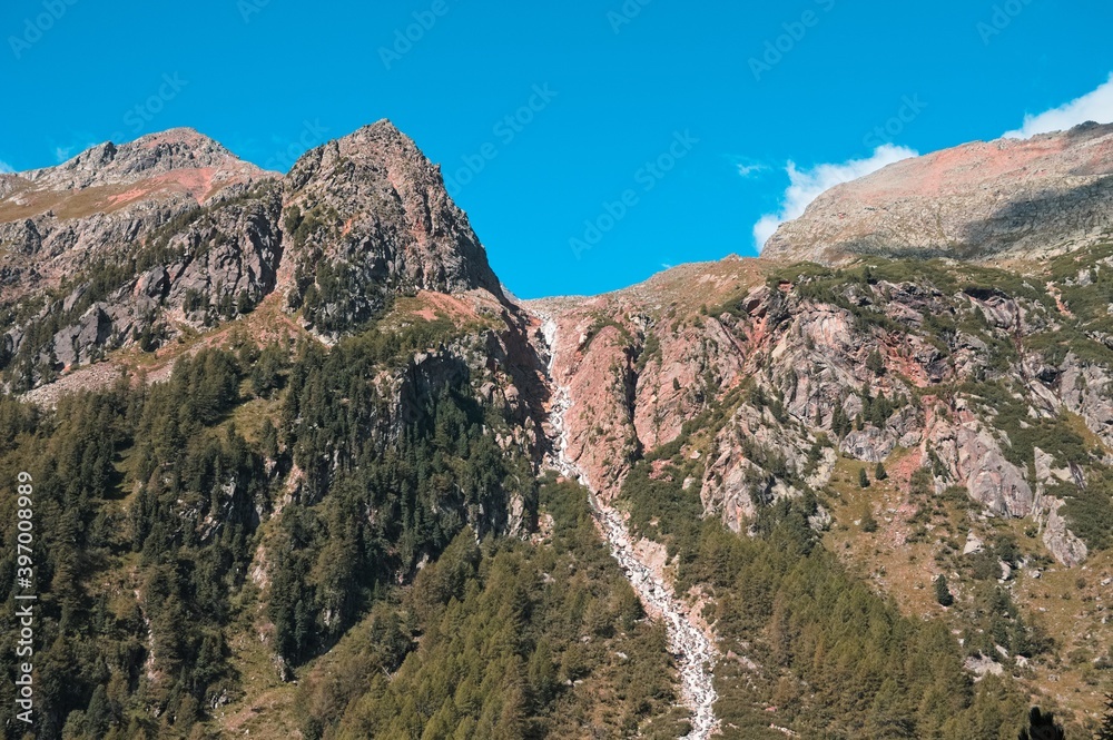 An isolated waterfall on the top of a mountain (Alps, Trentino, Italy) An isolated waterfall on the top of a mountain (Alps, Trentino, Italy)