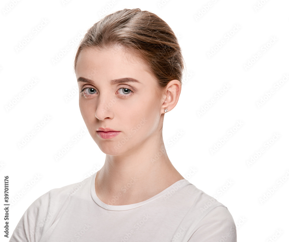 Portrait of young serious girl with perfect smooth skin on white background Portrait of young serious girl with perfect smooth skin on white background