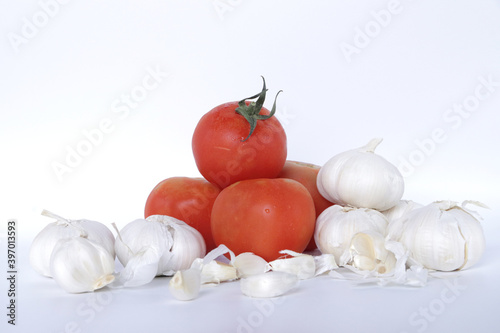 Fresh Vegetable Onion Tomato Ginger Garlic green chilly on white background photo