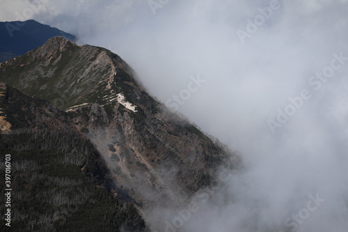 Mountain ridge covered with deep cloud