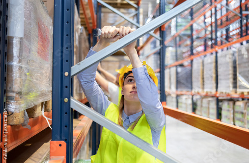 Worker during rack arrangement erection work in warehouse