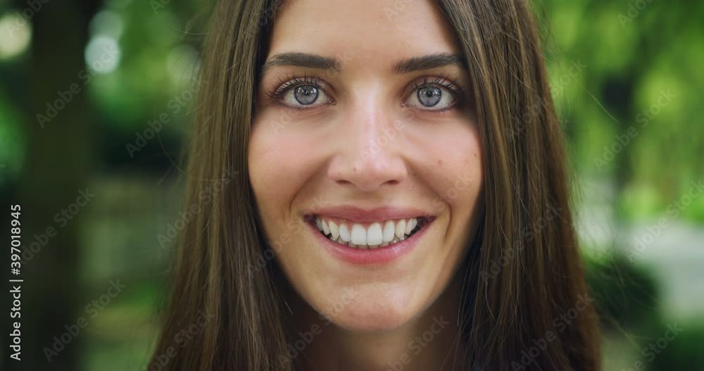 Cinematic close up shot of an young carefree happy woman with perfect smile is smiling in camera in green city park on a sunny day. Perfect teeth
Cinematic close up shot of an young carefree happy woman with perfect smile is smiling in camera in green city park on a sunny day. Perfect teeth