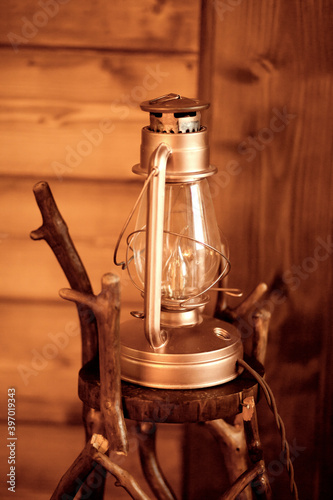 Old fashioned vintage retro lantern lamp on the wooden background. photo