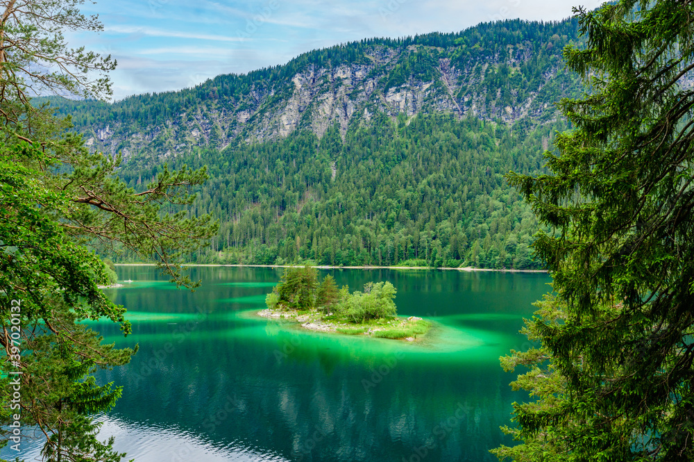 Small islands with pine-trees in the middle of Eibsee lake with ...