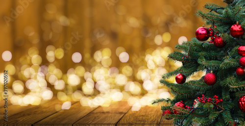 Fir Tree decorated with christmas balls on rustic wood and sparkles light backgorund