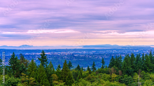 Evening view from Burnaby Mountain, BC, across Fraser Valley to Straits of Georgia and Gulf Islands in silhouette