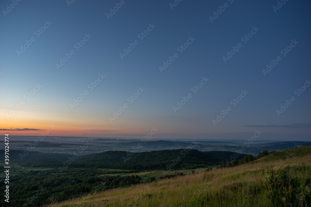 Panorama of a beautiful sunrise on the mountain in summer in Ukraine