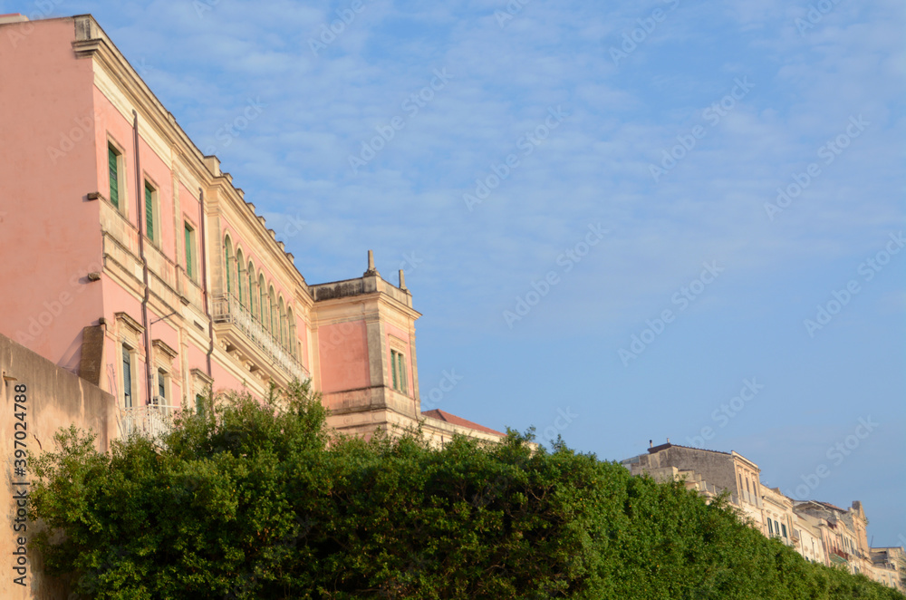 Italy / Syracuse – September 1, 2019: the elegant Art Nouveau buildings overlooking the Vittorio Emanuele II waterfront in Ortigia