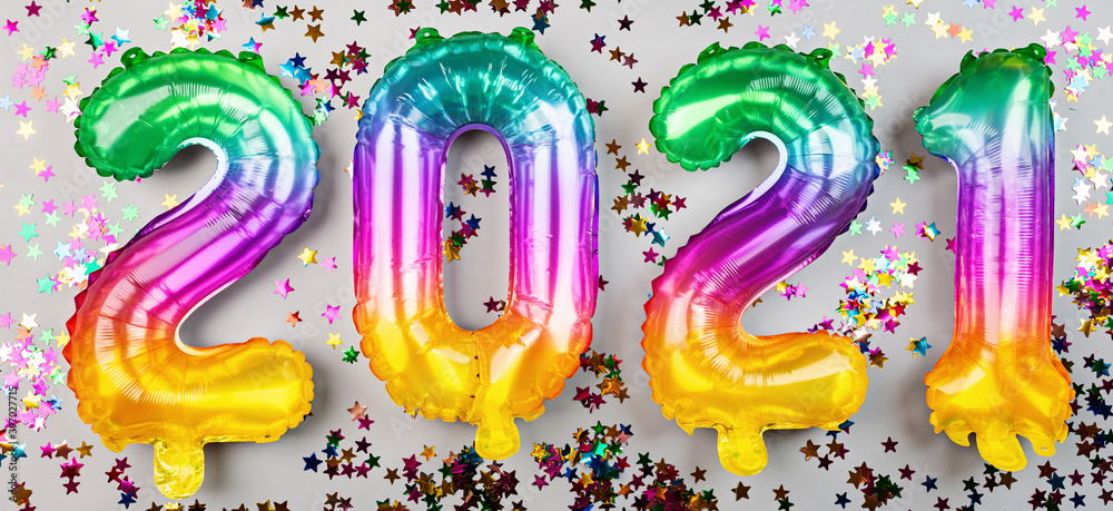 Happy new year 2021 background. Metallic balloons rainbow colors on white. Flat lay, top view, mockup, overhead. Winter holiday celebration Happy new year 2021 background. Metallic balloons rainbow colors on white. Flat lay, top view, mockup, overhead. Winter holiday celebration