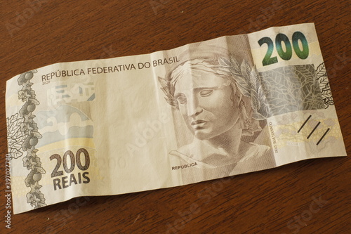 New note of two hundred Brazilian reais on a table. photo