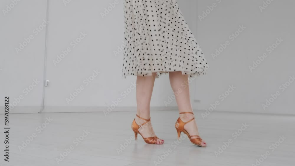 Young beautiful girl dancing ballroom dancing. A professional ballroom dancer is engaged in a large white hall. Young beautiful girl dancing ballroom dancing. A professional ballroom dancer is engaged in a large white hall.