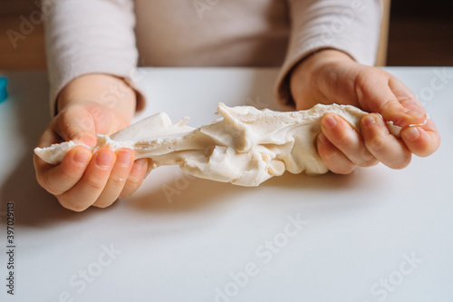 Konstfotografi Close view of child's hands playing with homemade playdough