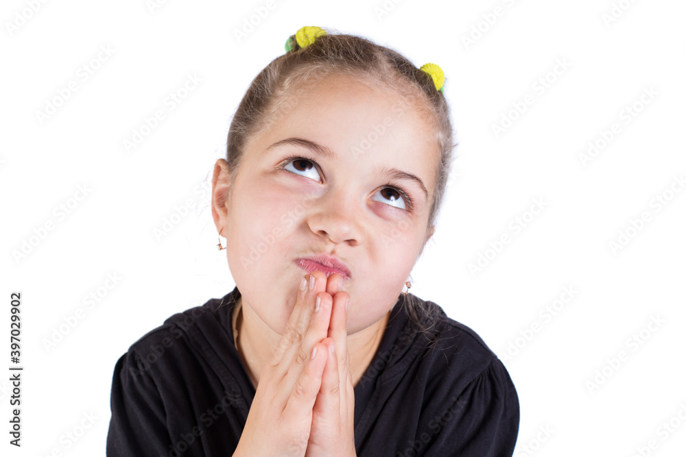 Little girl praying dreaming. Child makes a wish. Little girl praying dreaming. Child makes a wish.
