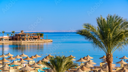 Relaxing at paradise beach - Chaise lounge and parasols - travel destination Hurghada, Egypt photo