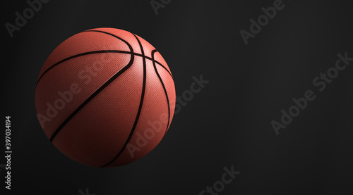 Basketball ball in flight. Dark background. Copy space. © Happyphotons