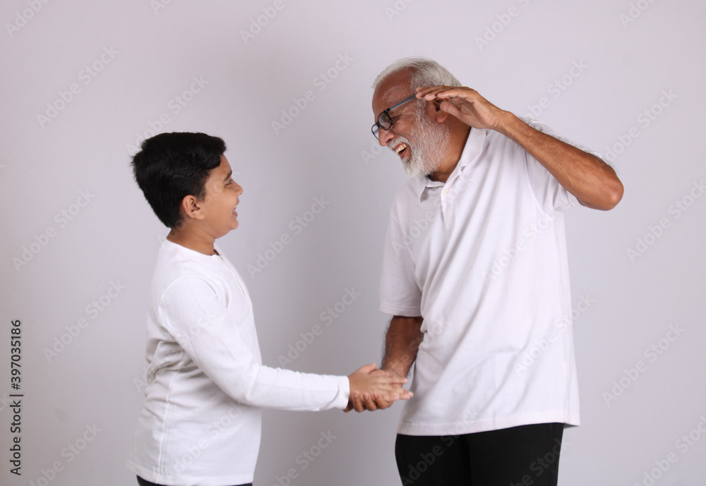 Happy Indian grandfather and grandson spending quality time Happy Indian grandfather and grandson spending quality time