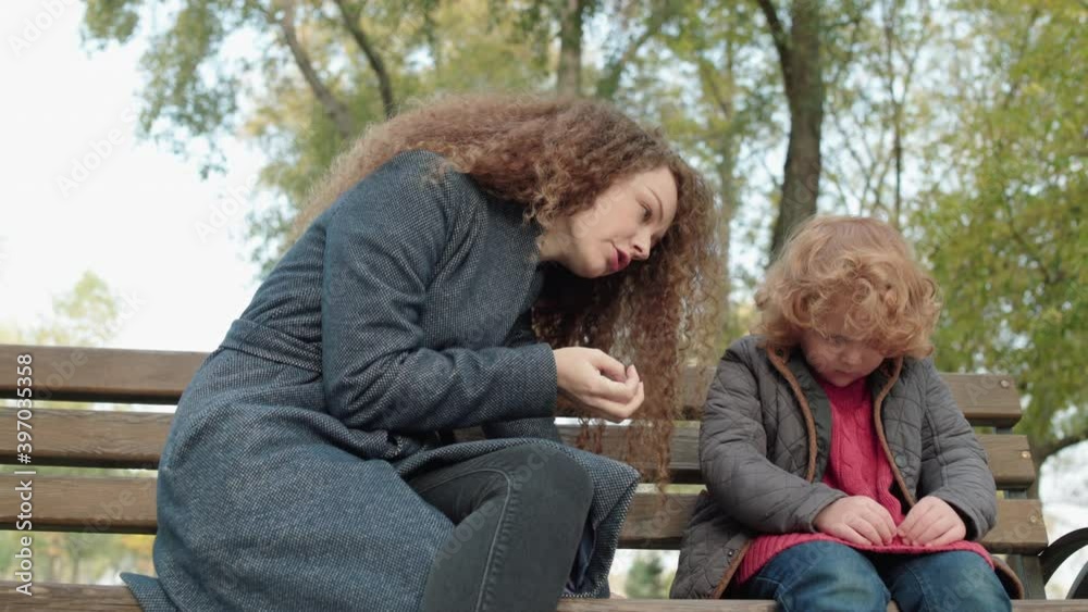 Angry mother arguing with small child outdoors, family problems, upbringing Angry mother arguing with small child outdoors, family problems, upbringing