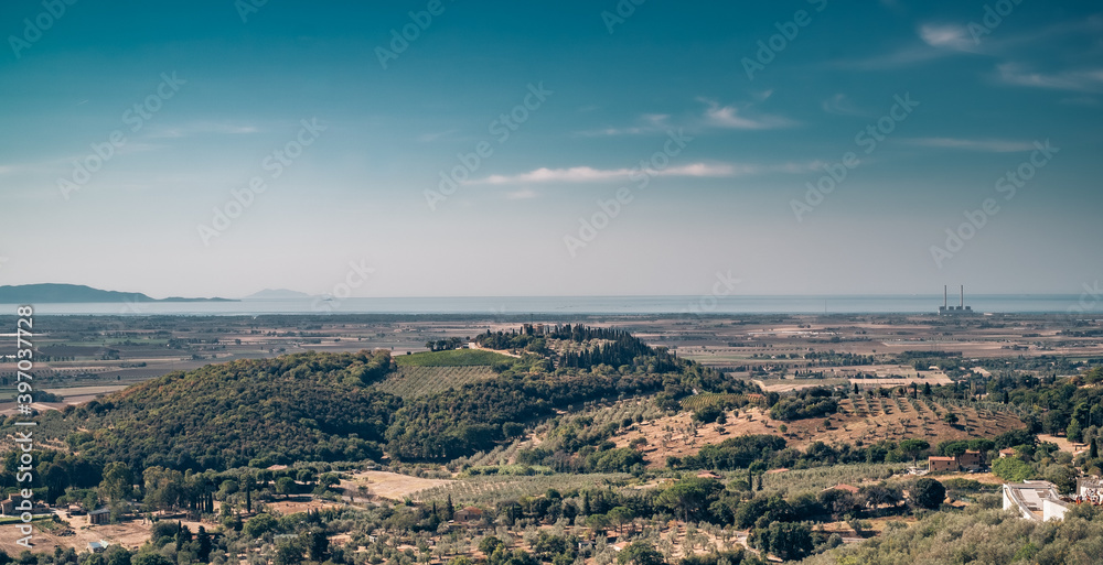 The cultivated hills and plain in front of the gulf of Follonica. Grosseto province, Tuscany, Italy.