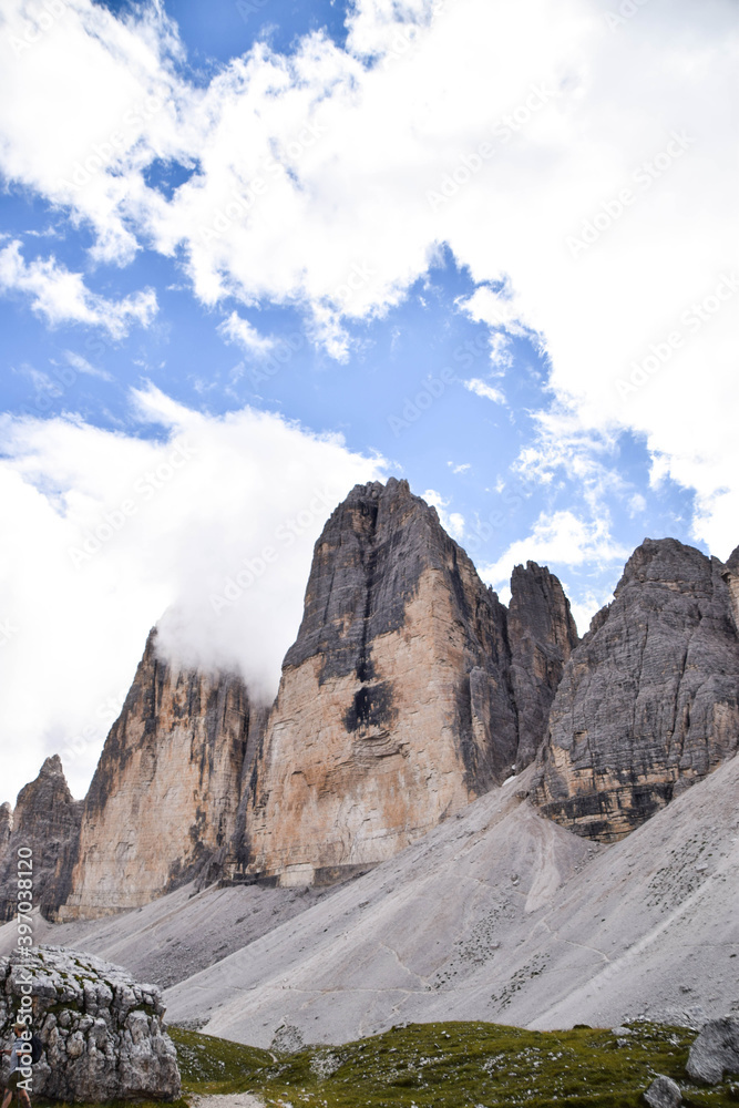 The National Park Tre Cime di Lavaredo. The three  peaks. Blue sky, clouds, mountains, landscape, dolomites, alps.