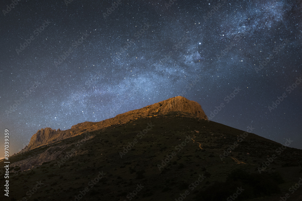 Milky way over rocky mountain and very starry and magical sky