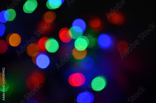 Abstract pattern of colorful bokeh lights on a dark background
