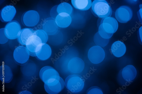 Abstract pattern of blue bokeh lights on dark background