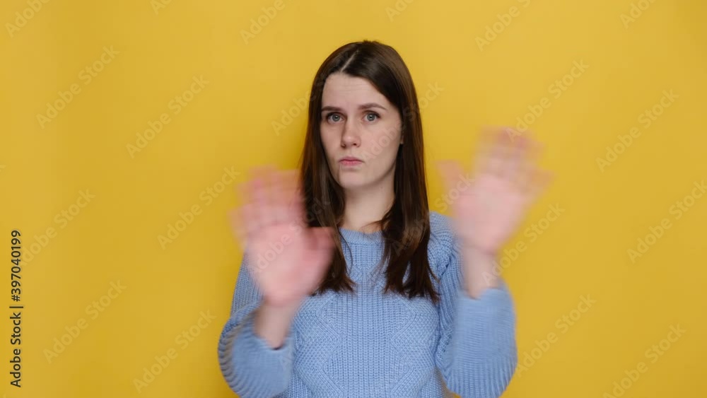 Portrait of confused young woman pointing fingers herself ask say who me no thanks i do not need it, dressed in blue sweater, isolated on yellow background studio. Emotion people lifestyle concept Portrait of confused young woman pointing fingers herself ask say who me no thanks i do not need it, dressed in blue sweater, isolated on yellow background studio. Emotion people lifestyle concept