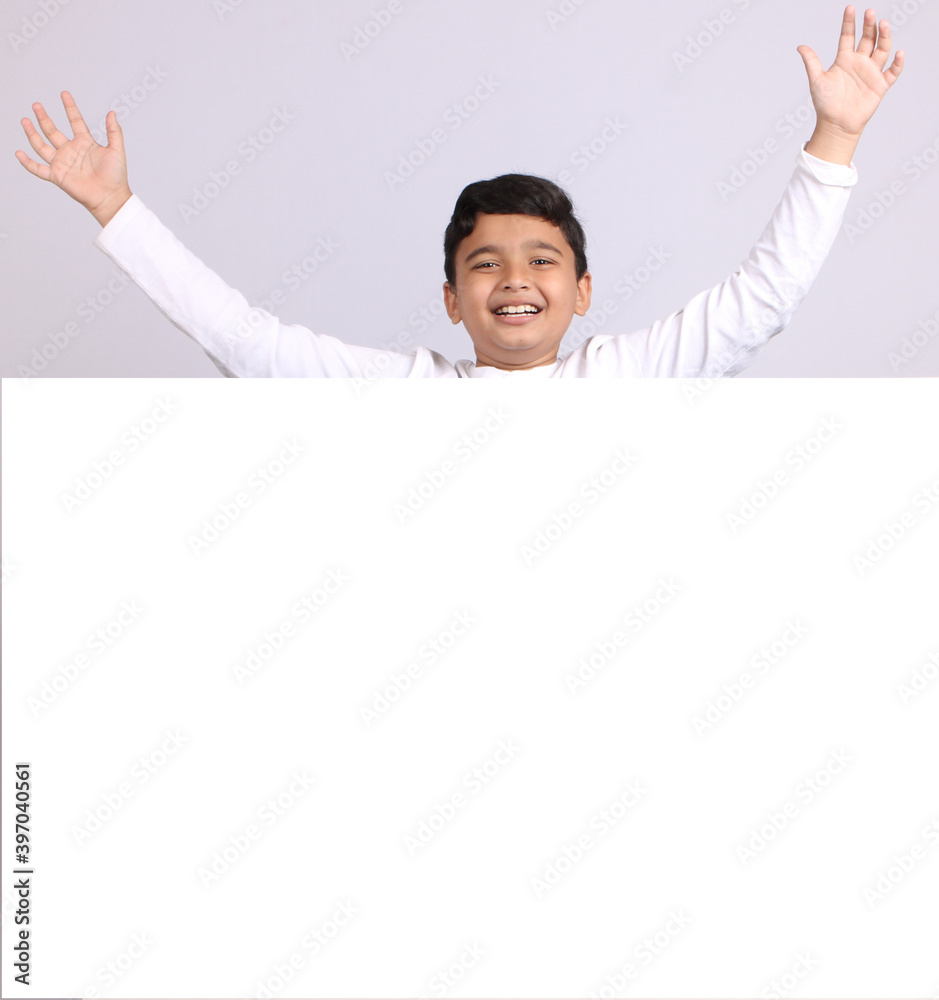 Young Indian schoolboy showing blank copy space. Young Indian schoolboy showing blank copy space.
