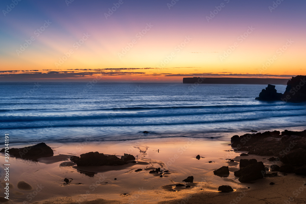 Scenic view of the Tonel Beach (Praia do Tonel) in Sagres, Algarve, at sunset, with the Cabo de Sao Vincente on the backround, in Portugal. Concept for travel in Portugal