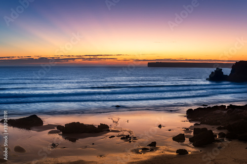 Scenic view of the Tonel Beach (Praia do Tonel) in Sagres, Algarve, at sunset, with the Cabo de Sao Vincente on the backround, in Portugal. Concept for travel in Portugal