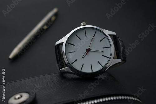 wrist watch with a notebook and a pen.Business man accessories.