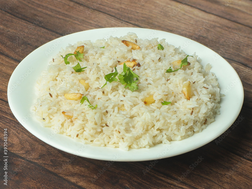 Cumin rice or Jeera Rice is a popular Indian main course item made using Basmati rice flavored with fried cumin seeds and basic spices, selective focus